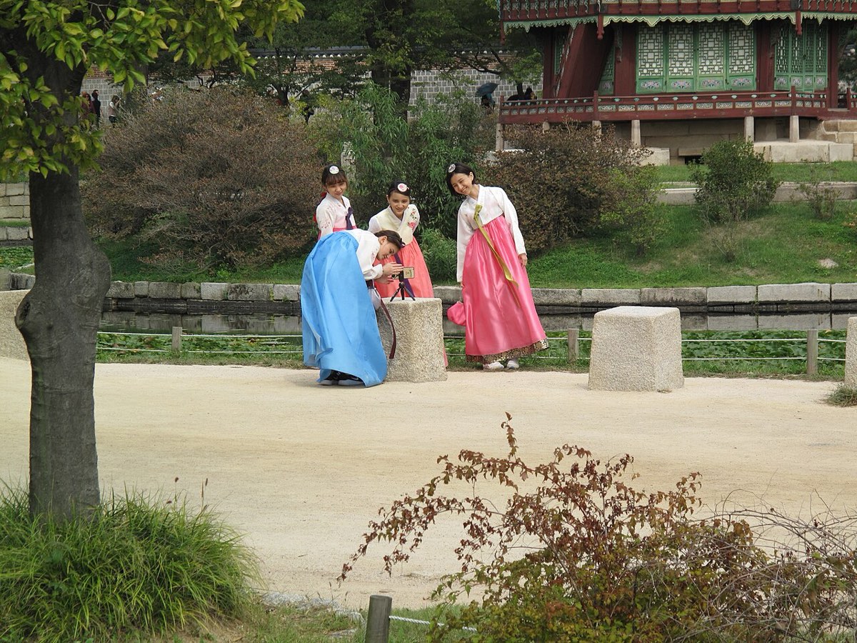 Visitors in rented hanbok pose for photos in the gardens of Gyeongbokgung Palace in Seoul.