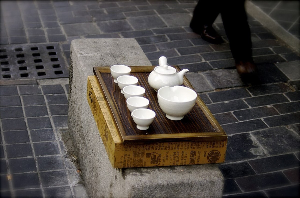 A Korean tea set with a small teapot and handleless cups arranged on a wooden tray in Insadong, Seoul.