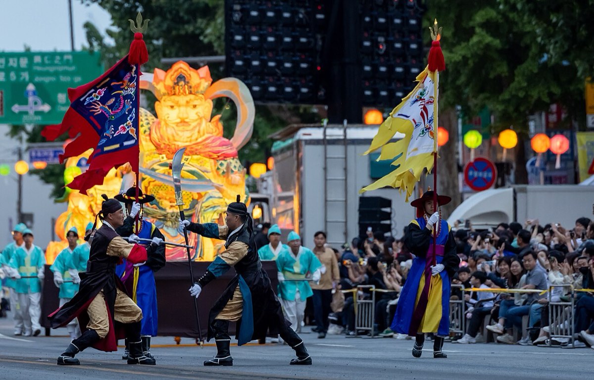 Costumed performers and an illuminated lantern float in the Lotus Lantern Festival parade in Jongno, Seoul, May 2023.