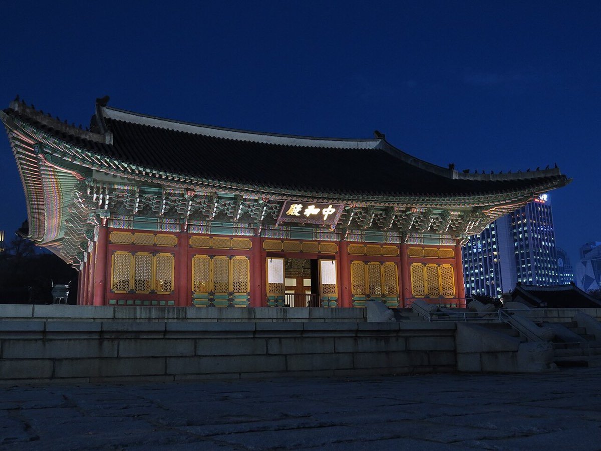 A hall of Deoksugung Palace illuminated after dark in central Seoul.
