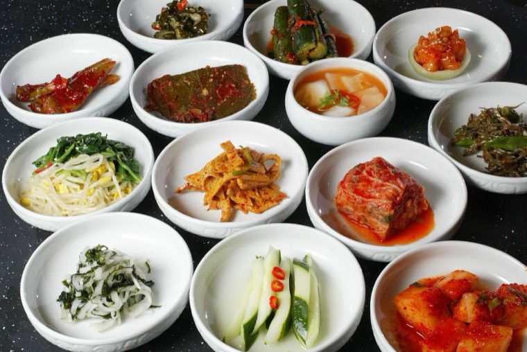 A Korean table set with many small shared side dishes (banchan)